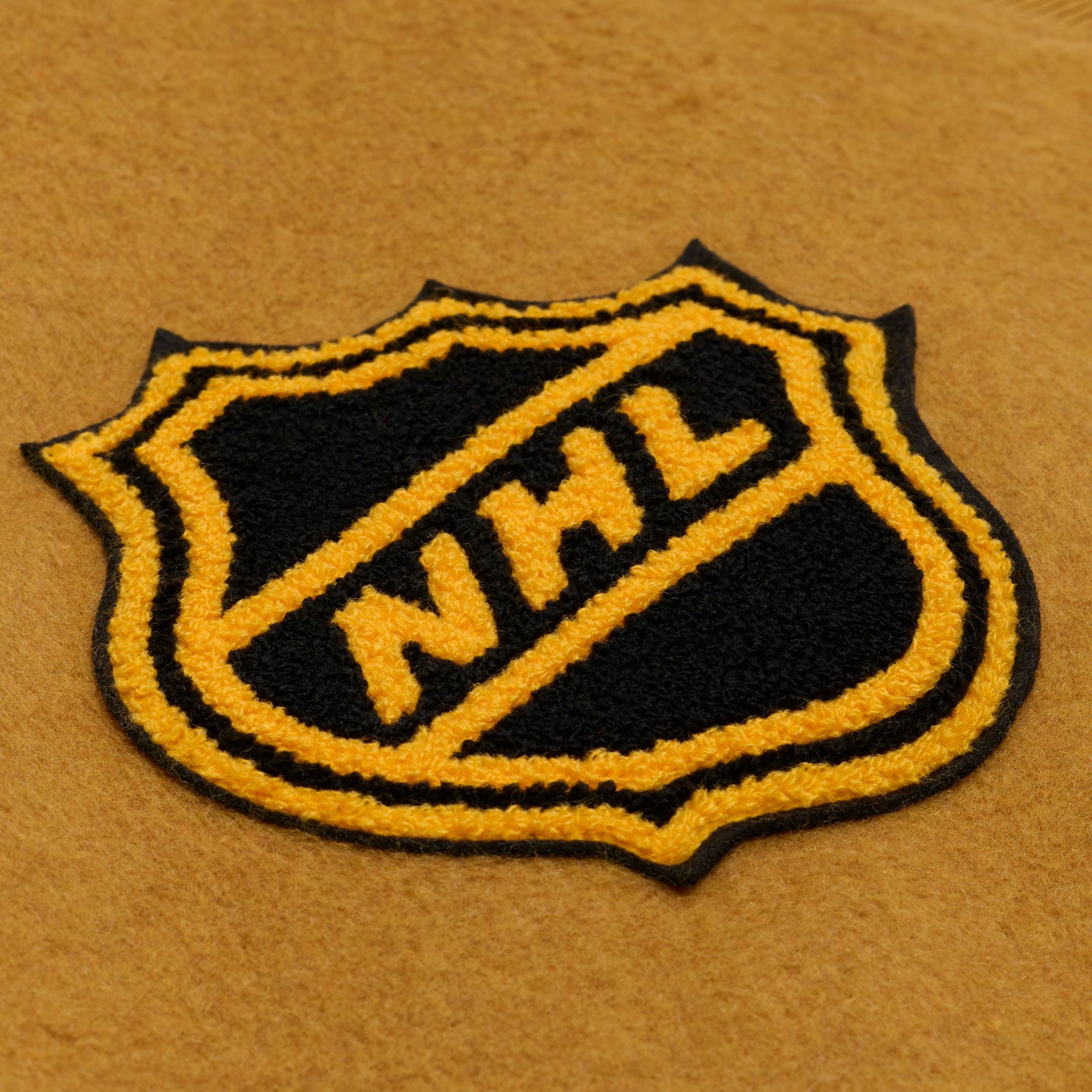 Mitchell & Ness Men's Boston Bruins Tan Dusted Varsity Jacket product image