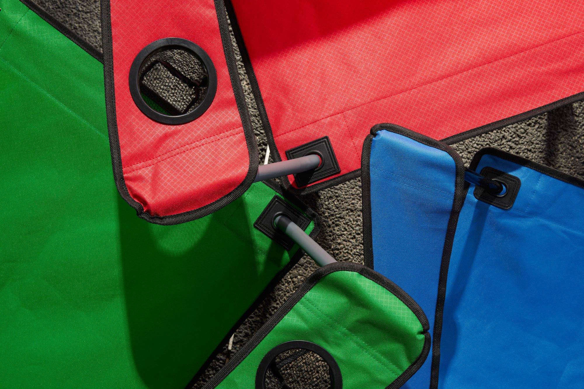 Detail of mesh fabric straps between chair colors.