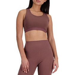 Puma Training mid support sports bra in pink with burgundy logo