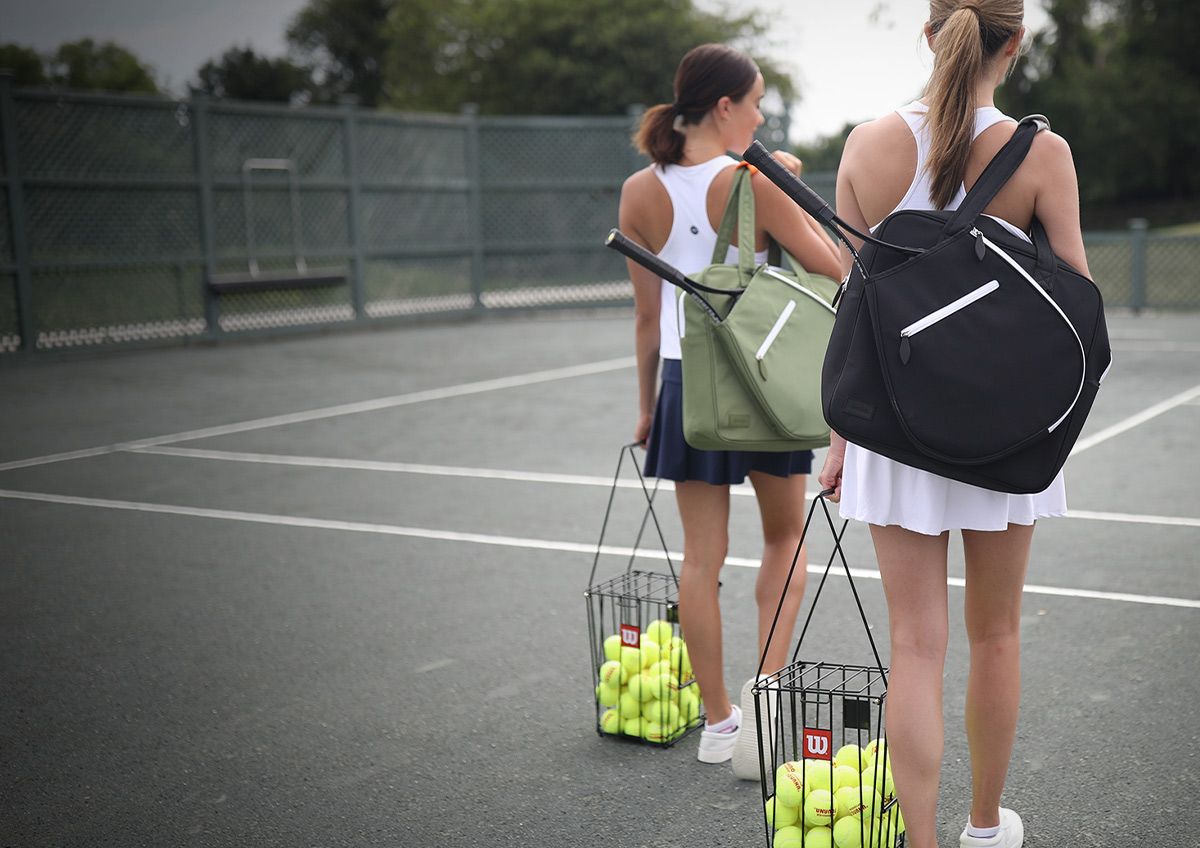 Two Female Tennis Players Getting Ready To Practice On The Court