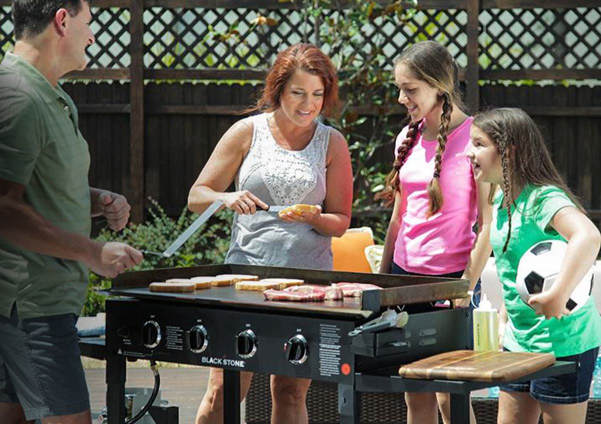 A family enjoys a cookout in their backyard.