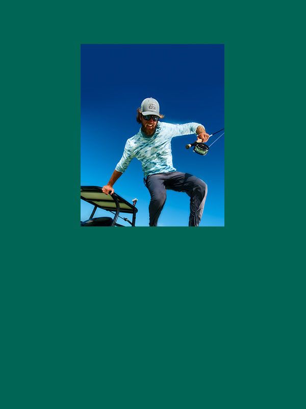 Man leaping with blue sky in background.
