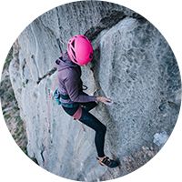 Person climbing a stone cliff
